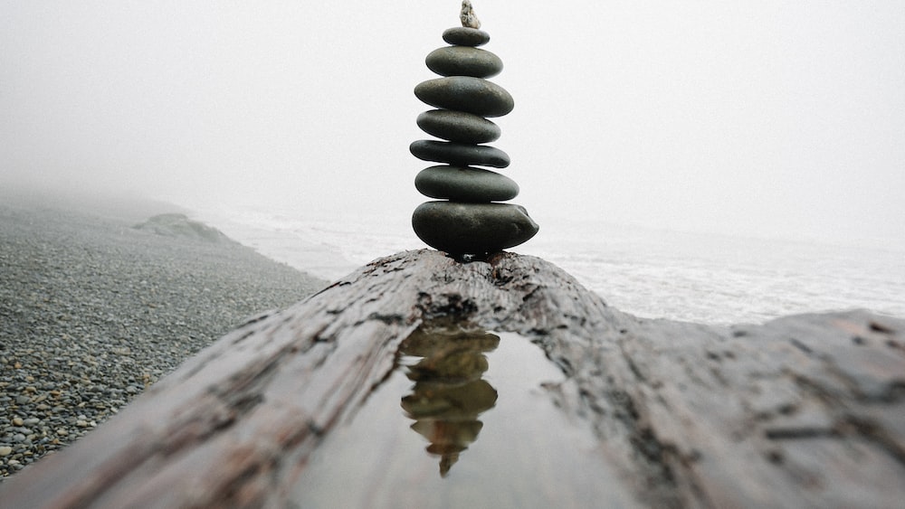 Balancing Stones on Gray Sand