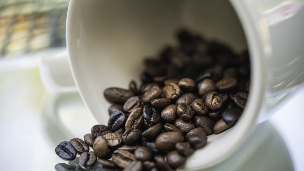 Caffeinated Delight: Roasted Coffee Beans and Mug Shot Close Up