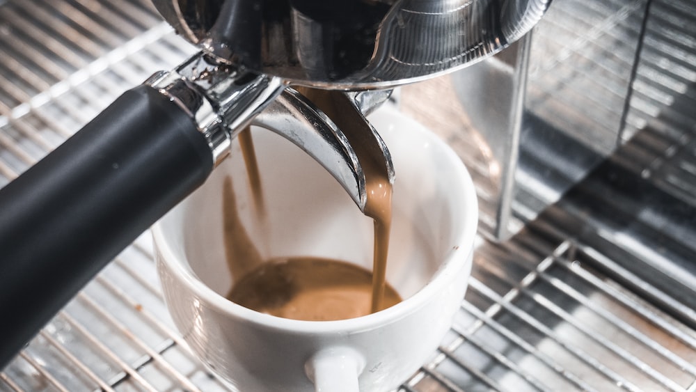 Caffeine brewing in a black coffee machine