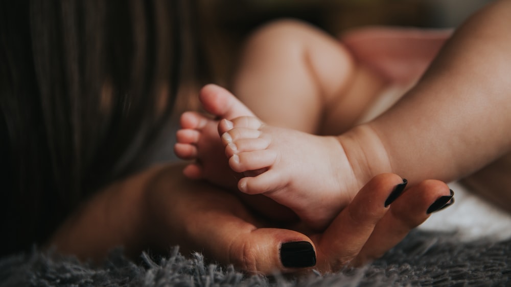 Pregnancy Support: A Mother's Gentle Touch on Her Newborn's Feet