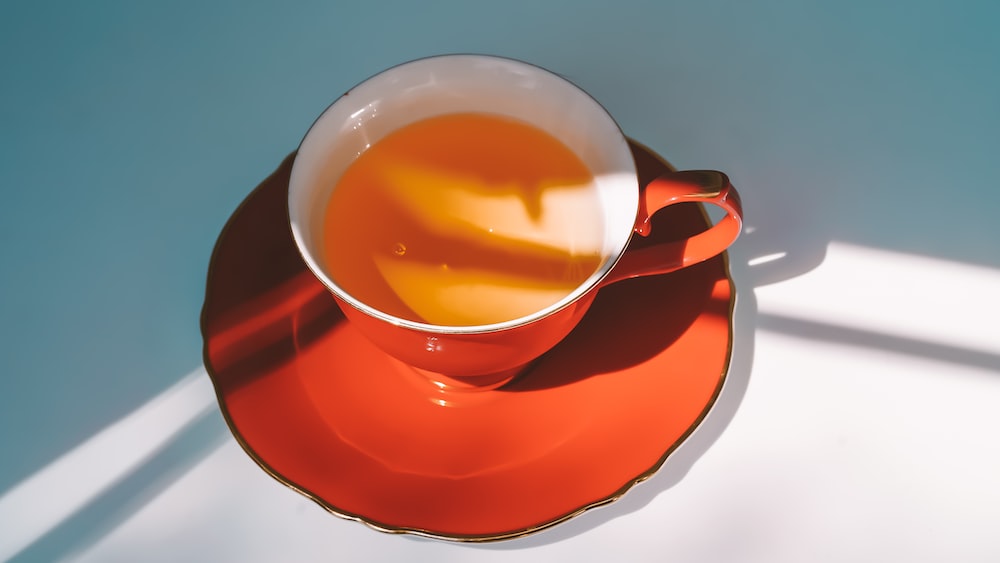 Red Ceramic Teacup and Saucer for Enjoying Tea