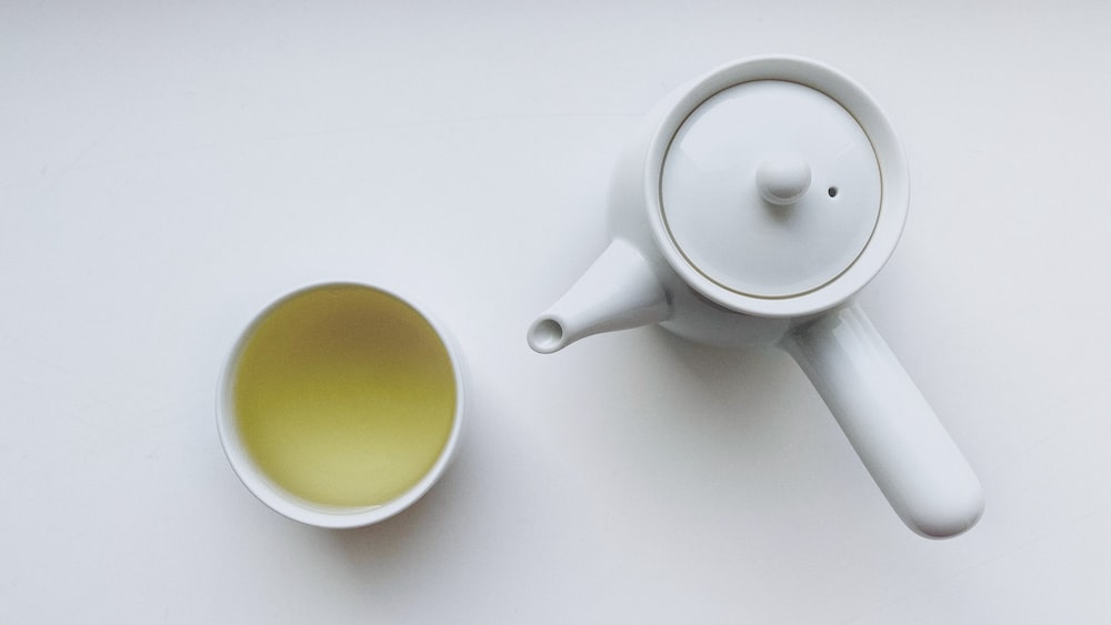 Refreshing Green Tea: A Ceramic Teapot and Mug