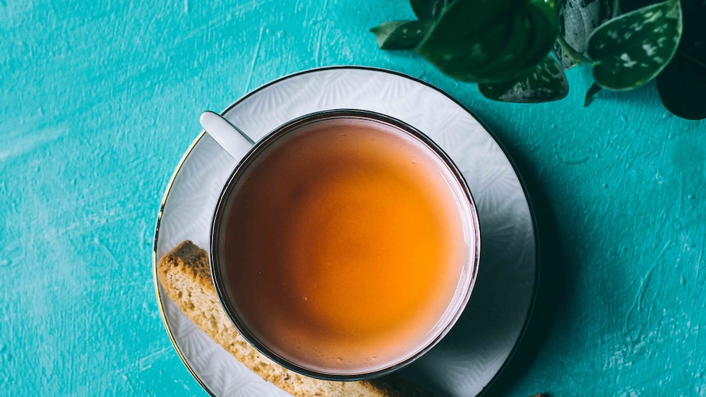 Refreshing Yellow Pu-Erh Tea Served in White Ceramic Teacup