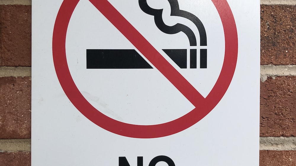 Restriction: No Smoking Sign on Brick Wall
