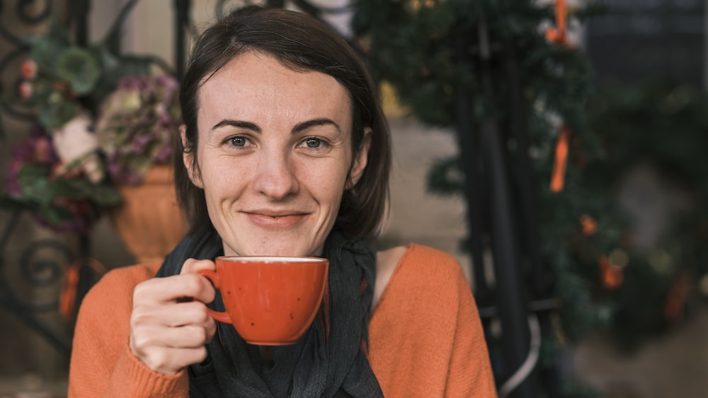 Risks of Caffeine: A Woman Enjoying a Hot Cup of Coffee