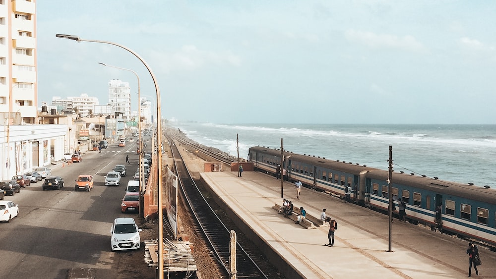 Serene Coastal Scene with Train and Cars