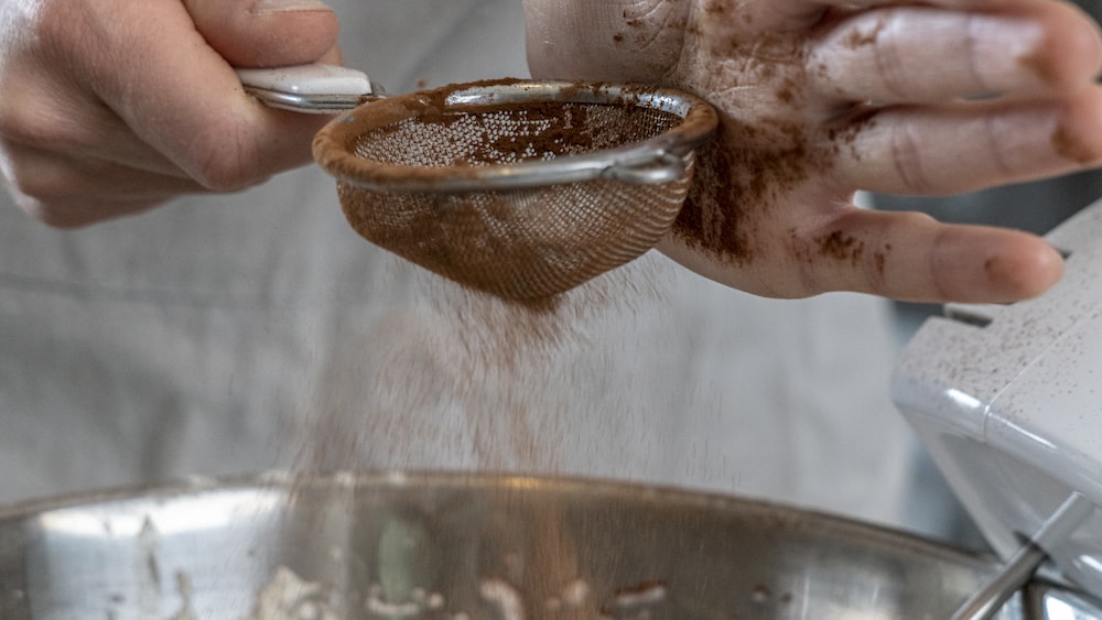 Sifting Cocoa Powder for Matcha Tea Preparation