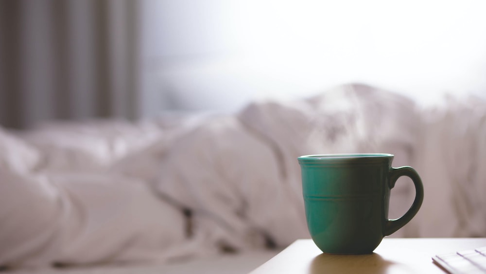Tea Brewing Essentials: Green Ceramic Mug on Wooden Desk