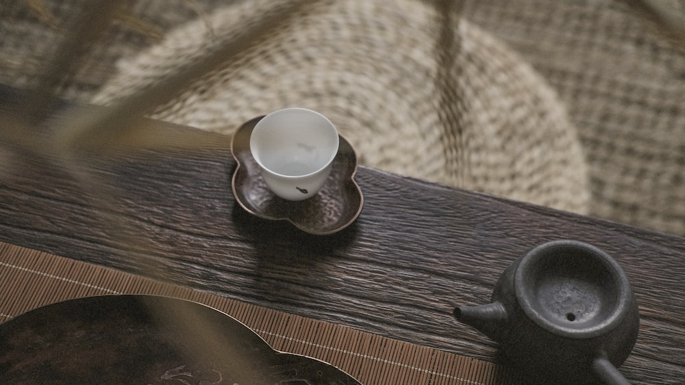 Tea Ceremony with a White Teacup and Teapot