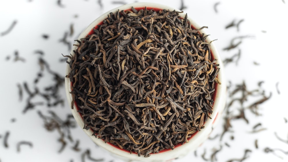Tea Leaves: A Close-up View of Puer Dry Tea in a Cup