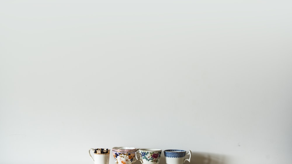 Tea Time: Assorted Ceramic Cups on White Table