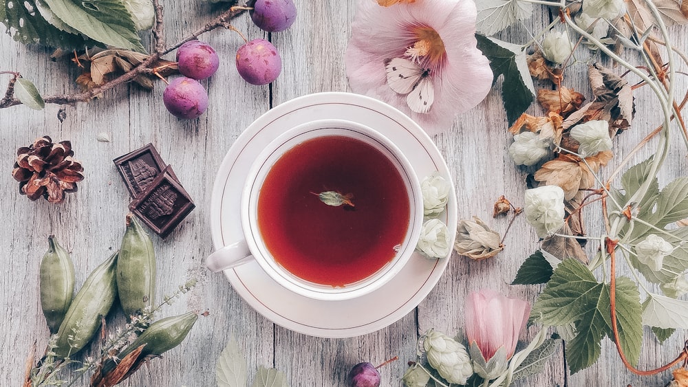 Tea Time Delight: Floral Petals and Ceramic Mug