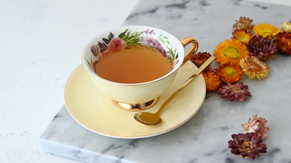 Tea and Flowers in a White Ceramic Teacup
